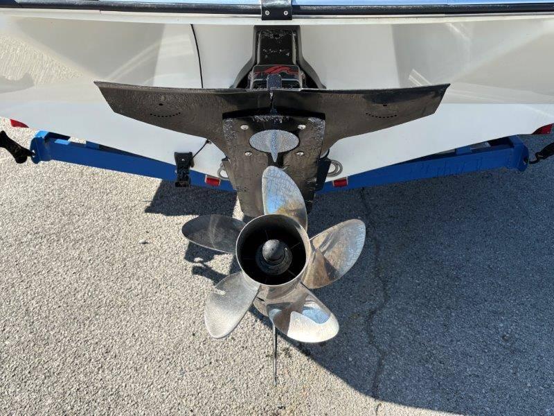 Slide: The Image of 1994 Rinker 209 Captiva boat propeller and stern view on pavement. - 32