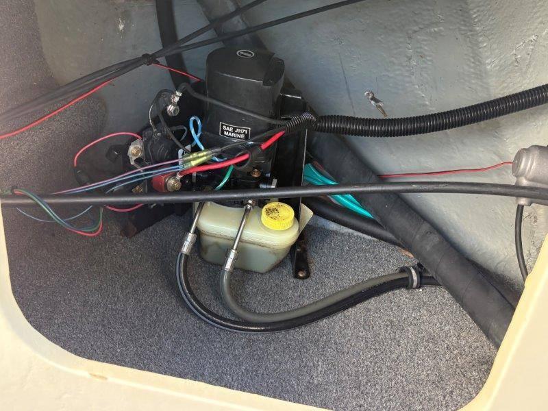 Slide: The Image of 1994 Rinker 209 Captiva boat engine compartment with wiring and fluid reservoir. - 33