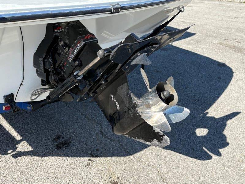 Slide: The Image of 1994 Rinker 209 Captiva boat propeller and outdrive on pavement. - 37