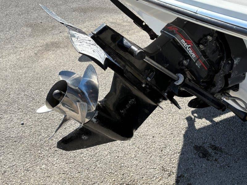 Slide: The Image of 1994 Rinker 209 Captiva boat propeller and outdrive on pavement. - 39