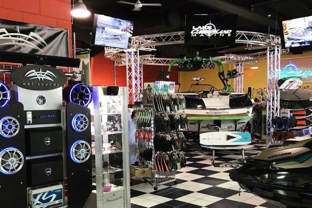 Slide: The Image of Marine store interior with Rinker 209 Captiva boat, audio equipment, and water sports gear. - 42
