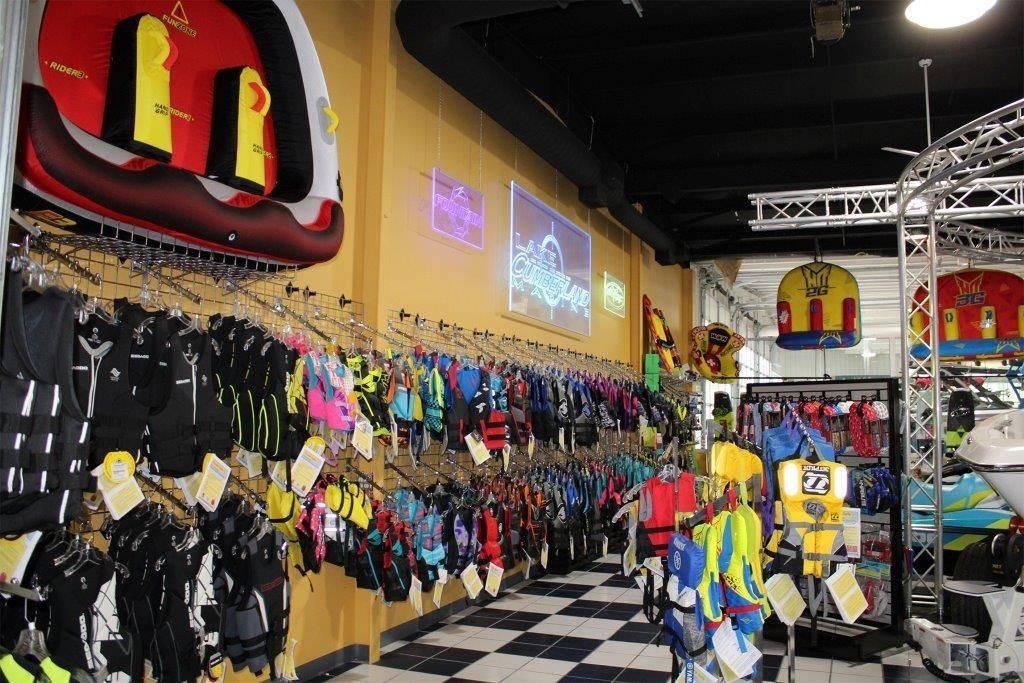 Slide: The Image of Water sports store with colorful life jackets and equipment on display. - 44