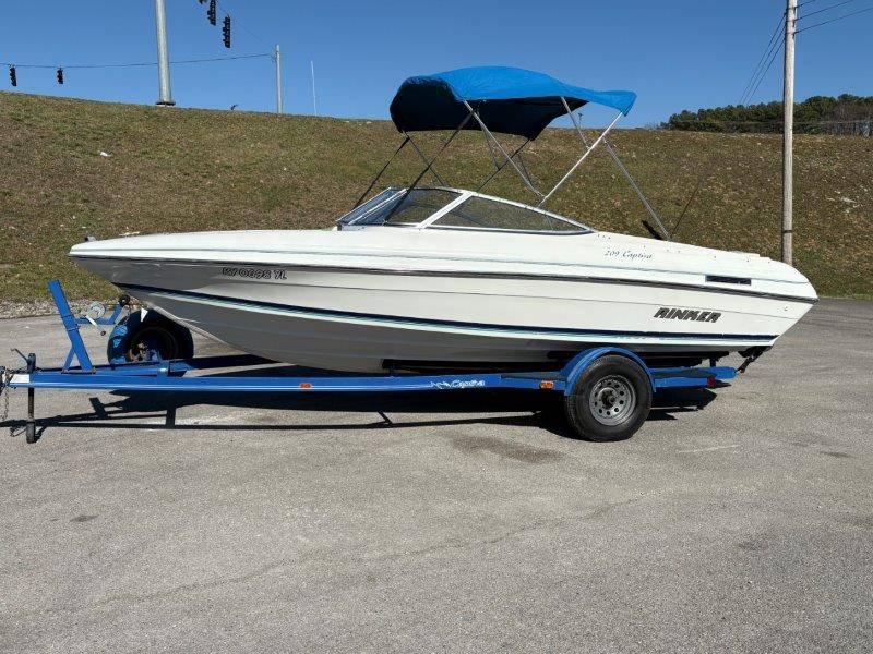 Slide: The Image of 1994 Rinker 209 Captiva boat on trailer with blue canopy, parked outdoors. - 47
