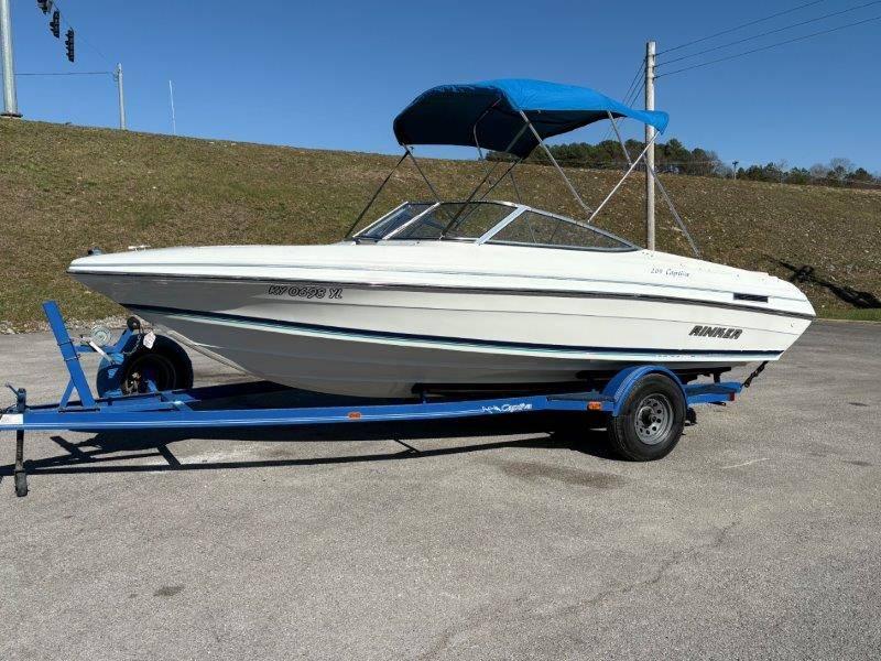 Slide: The Image of 1994 Rinker 209 Captiva boat on blue trailer with canopy, parked outdoors. - 48