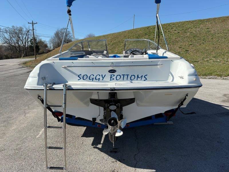 Slide: The Image of 1994 Rinker 209 Captiva boat named "Soggy Bottoms" parked on a sunny day. - 5
