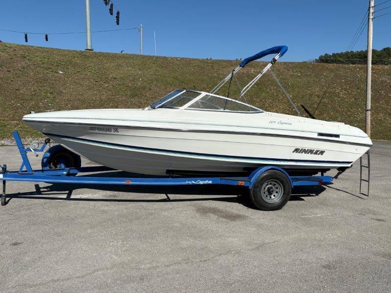 Slide: The Image of 1994 Rinker 209 Captiva boat on blue trailer, parked outdoors. - 6