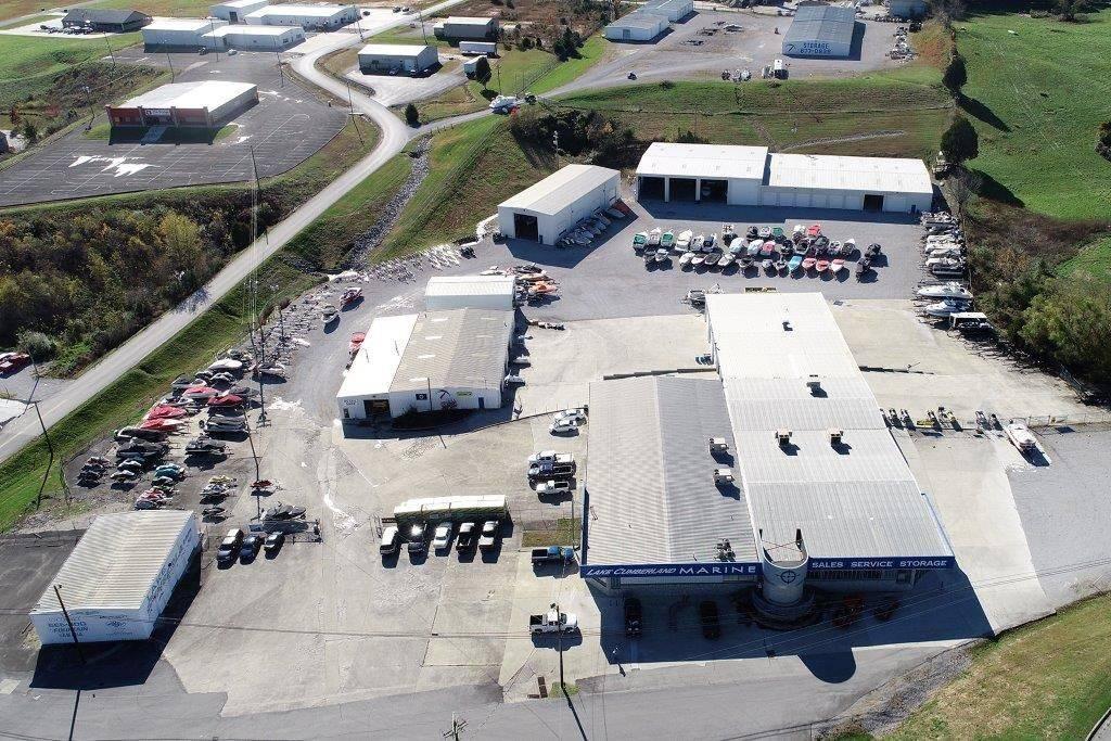 Slide: The Image of Aerial view of a marine sales and service facility with multiple boats and vehicles. - 8