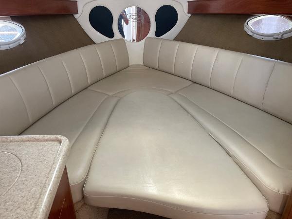 Slide: The Image of Interior of 2008 Rinker 260 Express Cruiser with beige leather seating. - 10