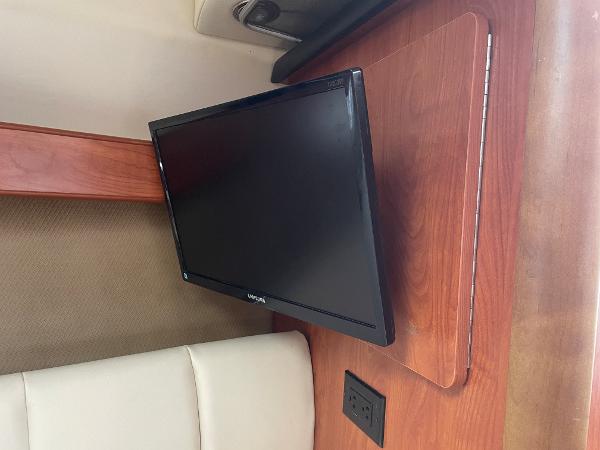 Slide: The Image of Flat-screen TV in 2008 Rinker 260 Express Cruiser cabin interior. - 12