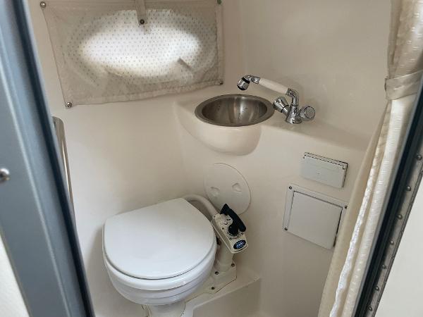Slide: The Image of 2008 Rinker 260 Express Cruiser bathroom with toilet and sink. - 13