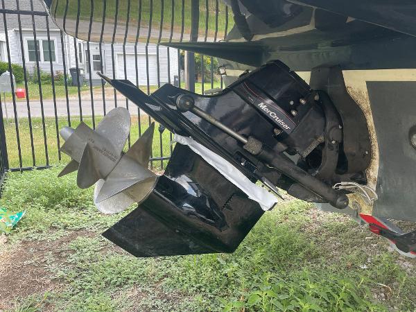 Slide: The Image of 2008 Rinker 260 Express Cruiser with MerCruiser outdrive, parked on grass. - 4