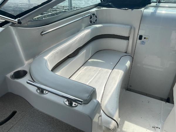 Slide: The Image of 2008 Rinker 260 Express Cruiser interior seating area with white upholstery. - 5