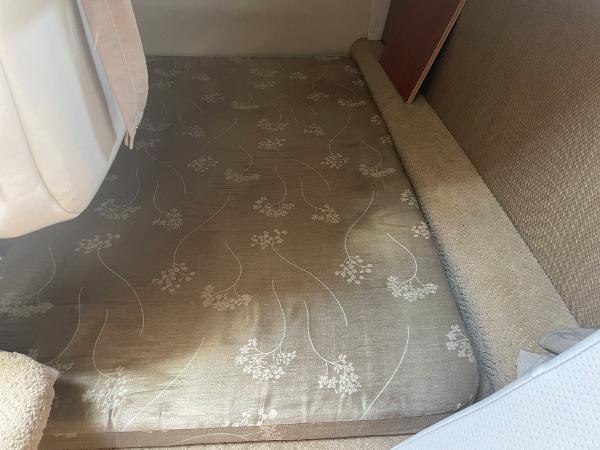 Slide: The Image of Interior cabin of 2008 Rinker 260 Express Cruiser with floral-patterned mattress. - 8