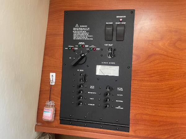 Slide: The Image of Control panel of a 2008 Rinker 260 Express Cruiser on a wooden surface. - 9