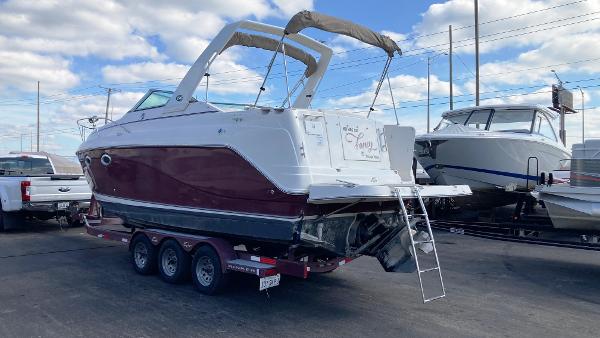 Slide: The Image of 2007 Rinker 270 Express Cruiser on a trailer in a marina. - 2