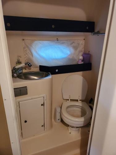 Slide: The Image of 2003 Rinker 270 Fiesta Vee Cr boat bathroom with sink, toilet, and storage. - 10