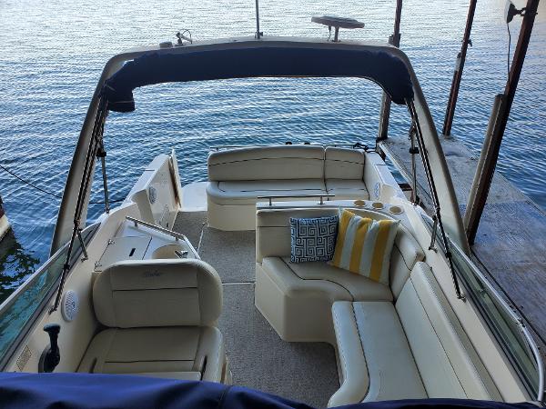Slide: The Image of 2003 Rinker 270 Fiesta Vee Cr boat interior with cushioned seating and decorative pillows. - 3