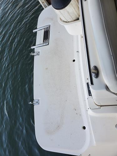 Slide: The Image of 2003 Rinker 270 Fiesta Vee Cr boat swim platform by the water. - 4