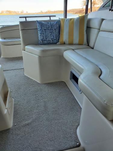 Slide: The Image of 2003 Rinker 270 Fiesta Vee Cr interior with plush seating and decorative cushions. - 7