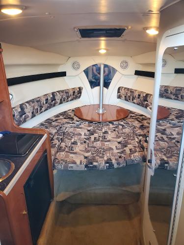 Slide: The Image of 2003 Rinker 270 Fiesta Vee Cr cabin interior with seating and table. - 9