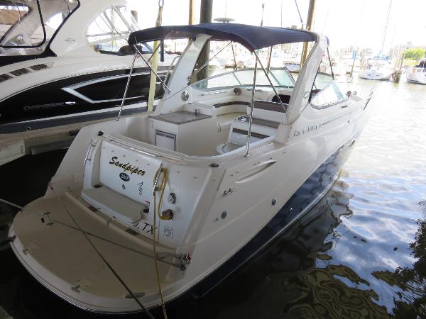 Slide: The Image of 2008 Rinker 280 Express Cruiser docked at marina, rear view. - 0