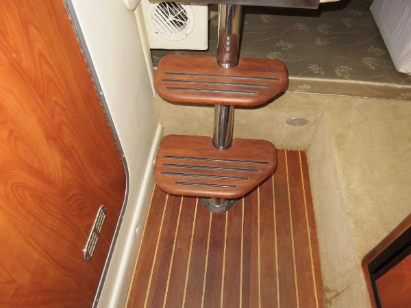 Slide: The Image of Wooden steps and flooring inside a 2008 Rinker 280 Express Cruiser boat. - 15