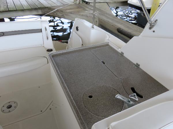 Slide: The Image of 2008 Rinker 280 Express Cruiser interior with a compact kitchenette and seating area. - 20