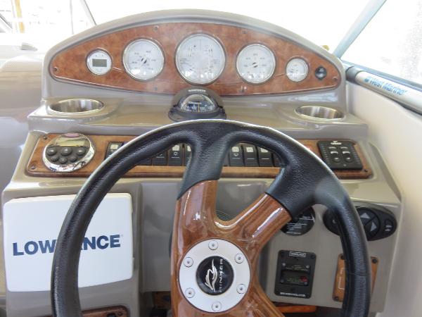 Slide: The Image of 2008 Rinker 280 Express Cruiser dashboard with steering wheel and instrument panel. - 9