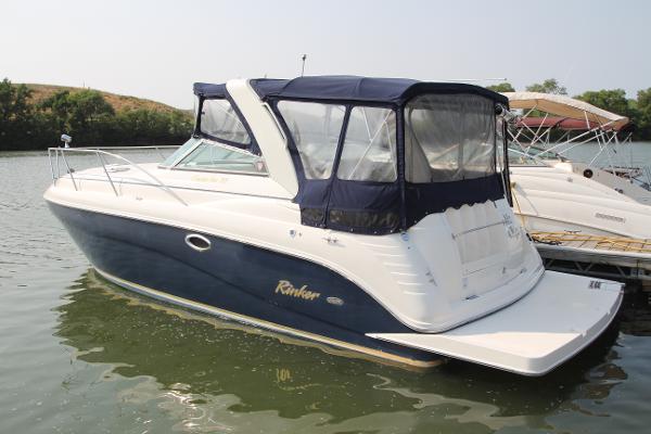 Slide: The Image of 2005 Rinker 312 Fiesta Vee boat docked on calm water. - 0