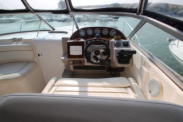 Slide: The Image of 2005 Rinker 312 Fiesta Vee boat cockpit with steering wheel and control panel. - 10