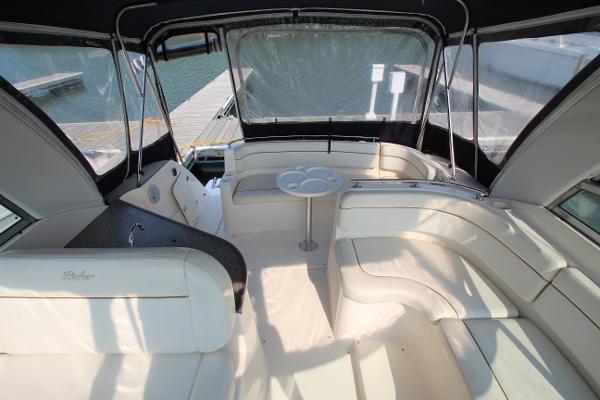 Slide: The Image of 2005 Rinker 312 Fiesta Vee boat interior with white seating and table. - 13
