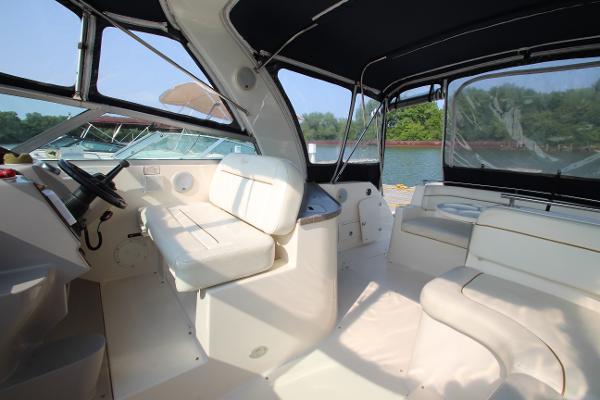 Slide: The Image of 2005 Rinker 312 Fiesta Vee boat interior with white seating and black canopy. - 15