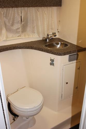 Slide: The Image of Compact bathroom in 2005 Rinker 312 Fiesta Vee boat with sink and toilet. - 20