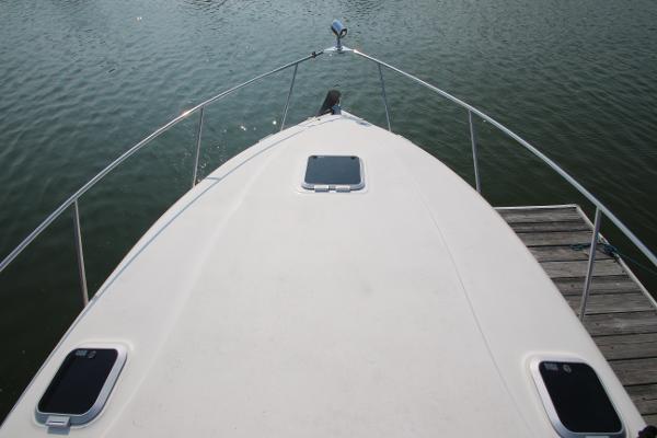 Slide: The Image of 2005 Rinker 312 Fiesta Vee boat bow view at dock. - 3