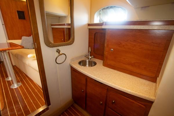 Slide: The Image of 2008 Rinker 400 Express Cruiser interior with wooden cabinetry and sink - 14