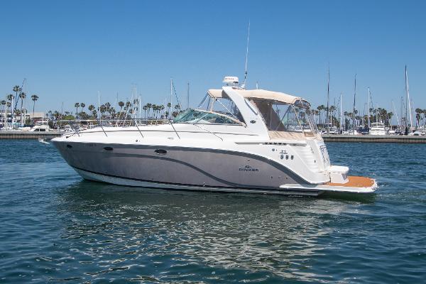Slide: The Image of 2008 Rinker 400 Express Cruiser on calm waters with marina background. - 21