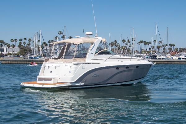 Slide: The Image of 2008 Rinker 400 Express Cruiser yacht on calm waters with marina background. - 24