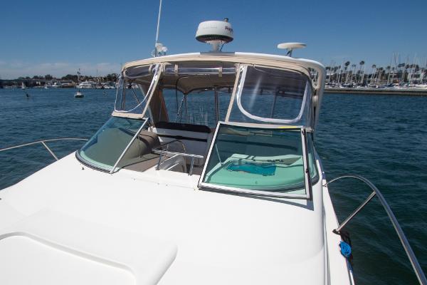 Slide: The Image of 2008 Rinker 400 Express Cruiser on calm waters with marina in background. - 26
