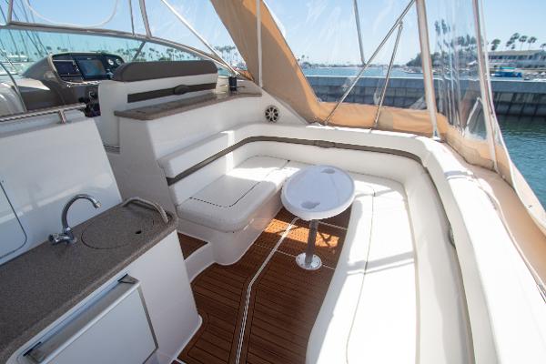 Slide: The Image of 2008 Rinker 400 Express Cruiser interior with seating, table, and kitchenette. - 7