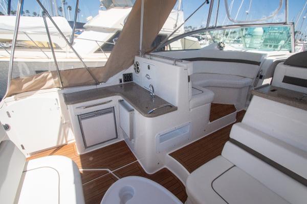 Slide: The Image of 2008 Rinker 400 Express Cruiser interior with kitchenette and seating area. - 8