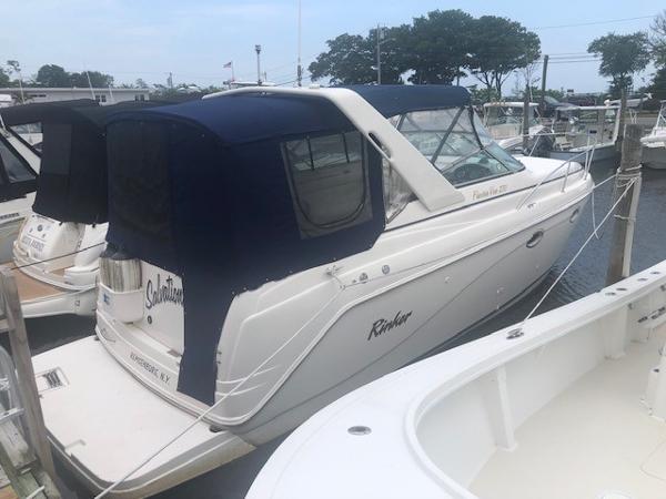 Slide: The Image of 2003 Rinker Fiesta Vee 270 boat docked at a marina. - 0