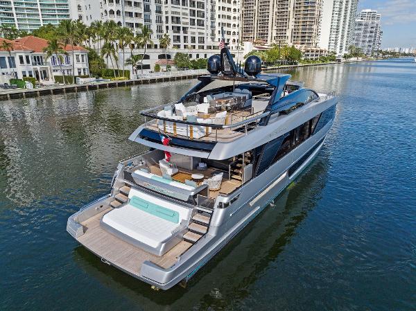 Slide: The Image of Luxury 2024 Riva 102 Corsaro Super yacht cruising near waterfront buildings. - 11