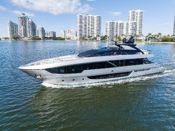 Slide: The Image of 2024 Riva 102 Corsaro Super yacht cruising near modern city skyline. - 14