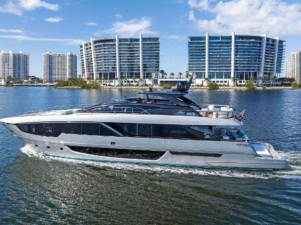Slide: The Image of 2024 Riva 102 Corsaro Super yacht cruising near modern waterfront buildings. - 16
