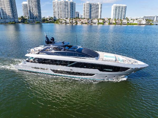 Slide: The Image of 2024 Riva 102 Corsaro Super yacht cruising on a sunny day near city skyline. - 18