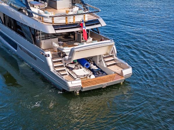 Slide: The Image of Luxury 2024 Riva 102 Corsaro Super yacht on water, showcasing open deck and storage area. - 19