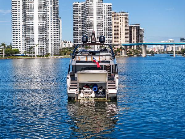 Slide: The Image of 2024 Riva 102 Corsaro Super yacht on urban waterfront with skyscrapers. - 21