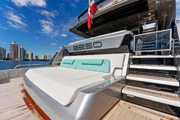 Slide: The Image of Luxurious 2024 Riva 102 Corsaro Super yacht with sun deck, docked by waterfront buildings. - 27