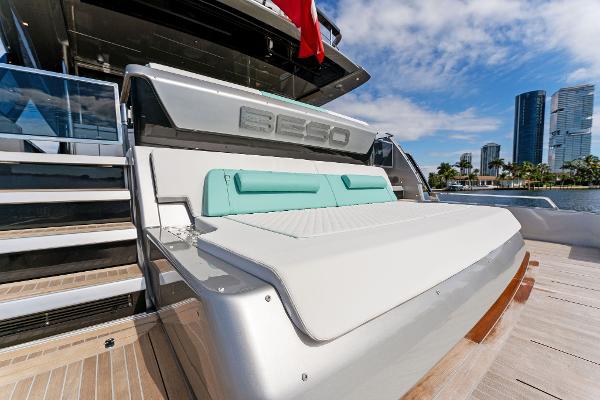 Slide: The Image of 2024 Riva 102 Corsaro Super yacht with sunbed, city skyline in background. - 29
