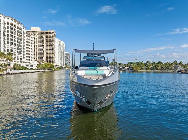 Slide: The Image of 2024 Riva 102 Corsaro Super yacht on a sunny waterfront with city skyline. - 3